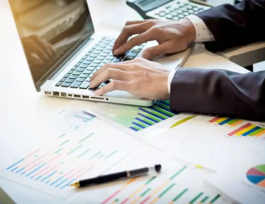Working process startup. Businessman working at the wood table with new finance project. Modern notebook on table. Pen holding hand